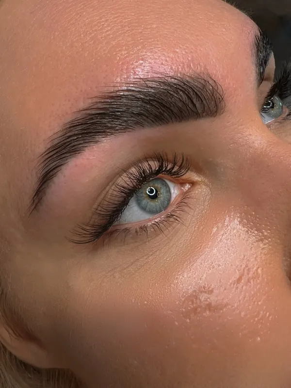 Close-up of lash extensions with laminated brows