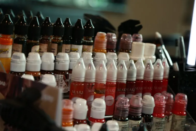 Permanent makeup pigment bottles lined up on a shelf